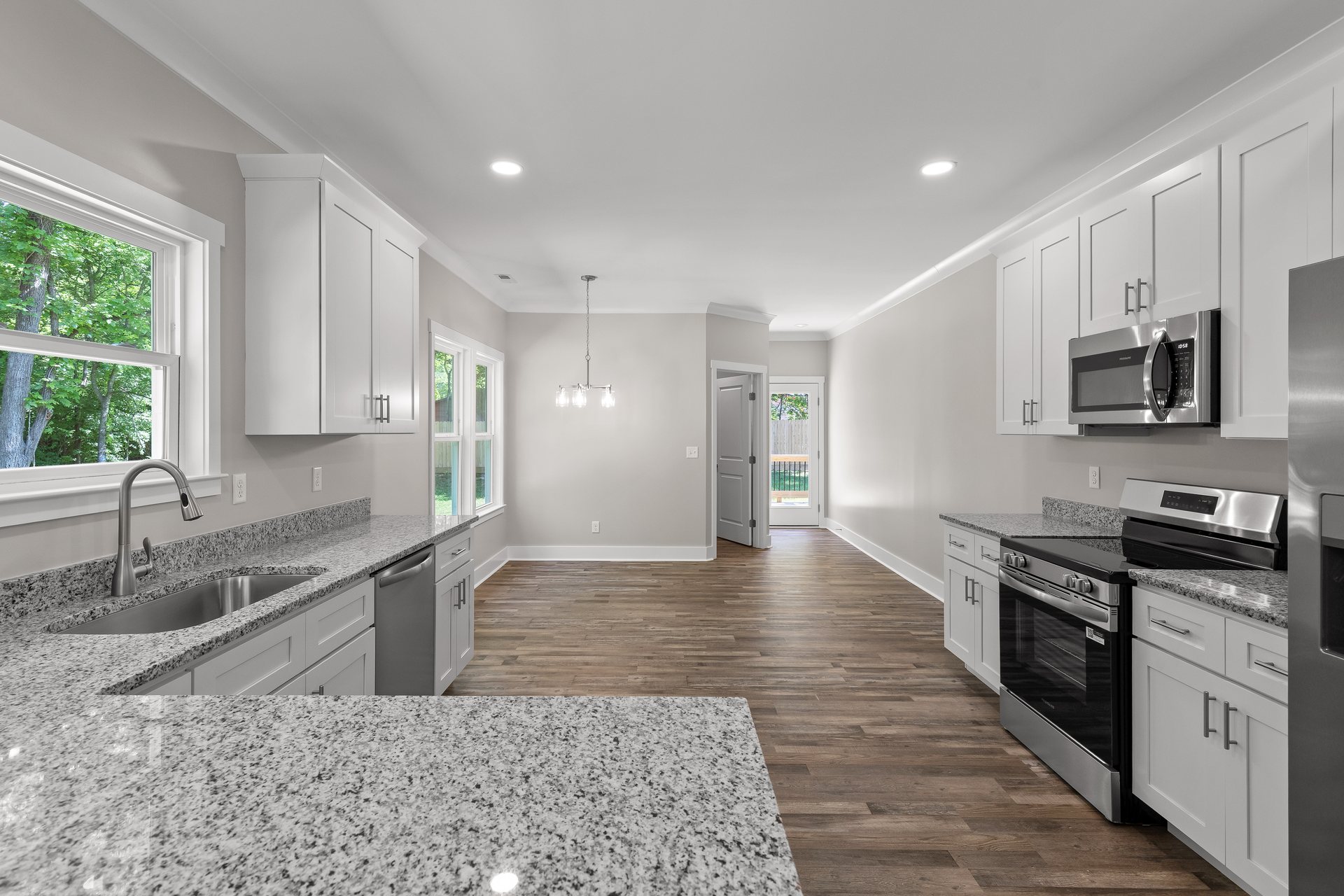 330 12th Ave kitchen with granite counters, white shaker cabinets, and an island