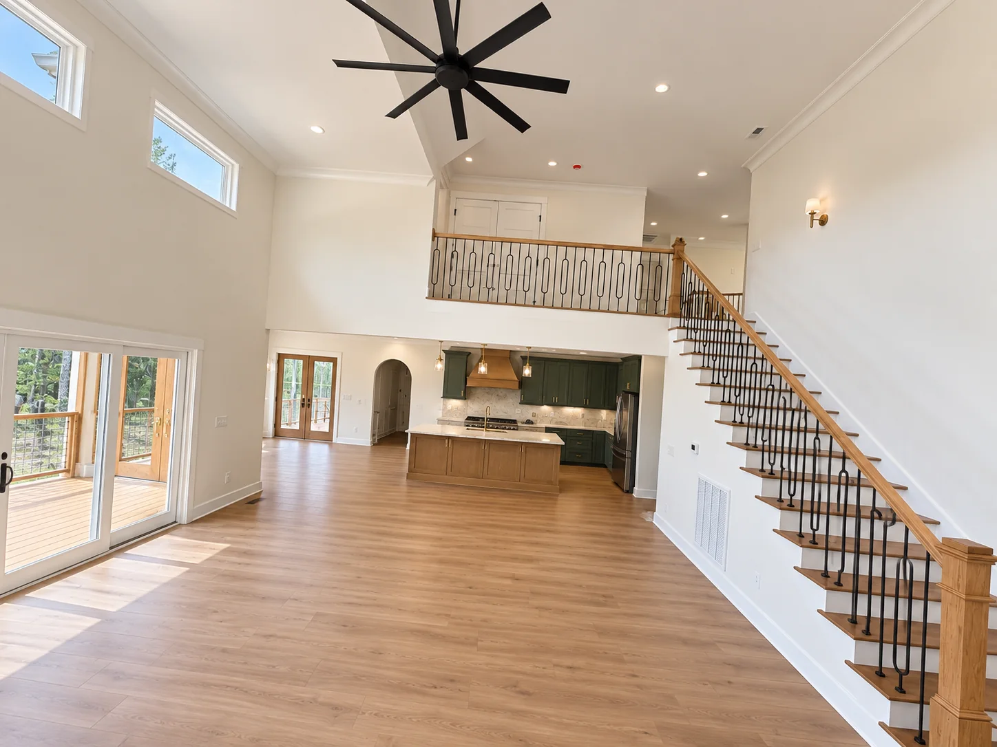 Fox Hill two-story great room with the loft railing and staircase above the kitchen
