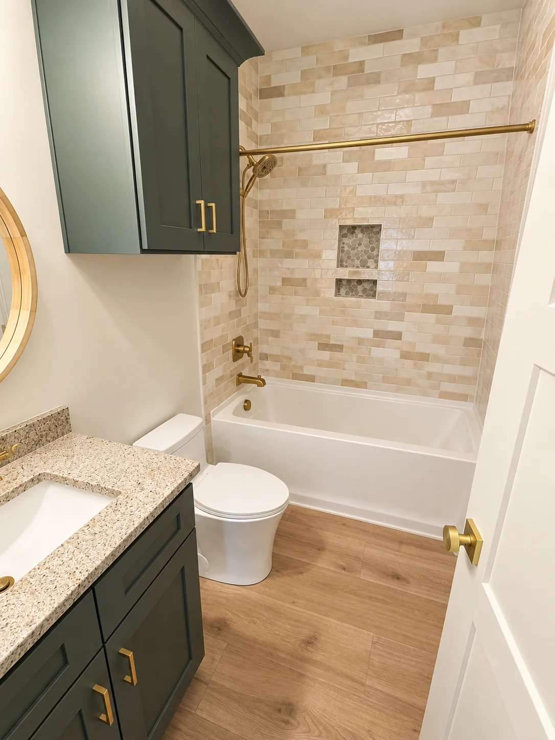 Fox Hill guest bath with a tiled tub surround and green vanity