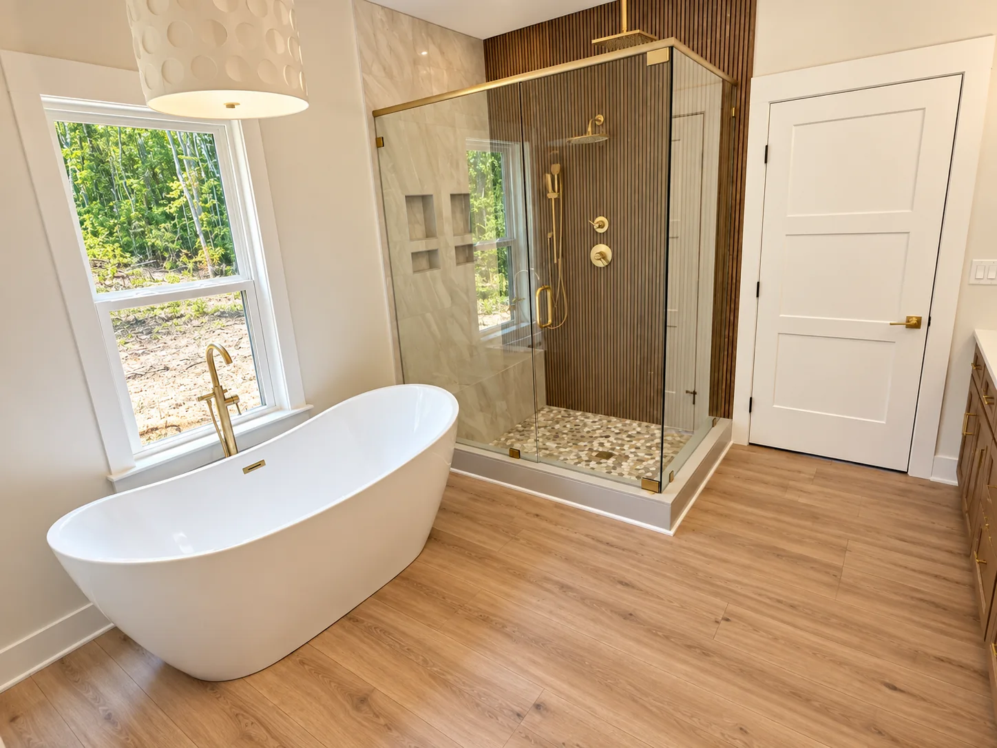 Fox Hill primary bath with a freestanding tub and glass-enclosed shower
