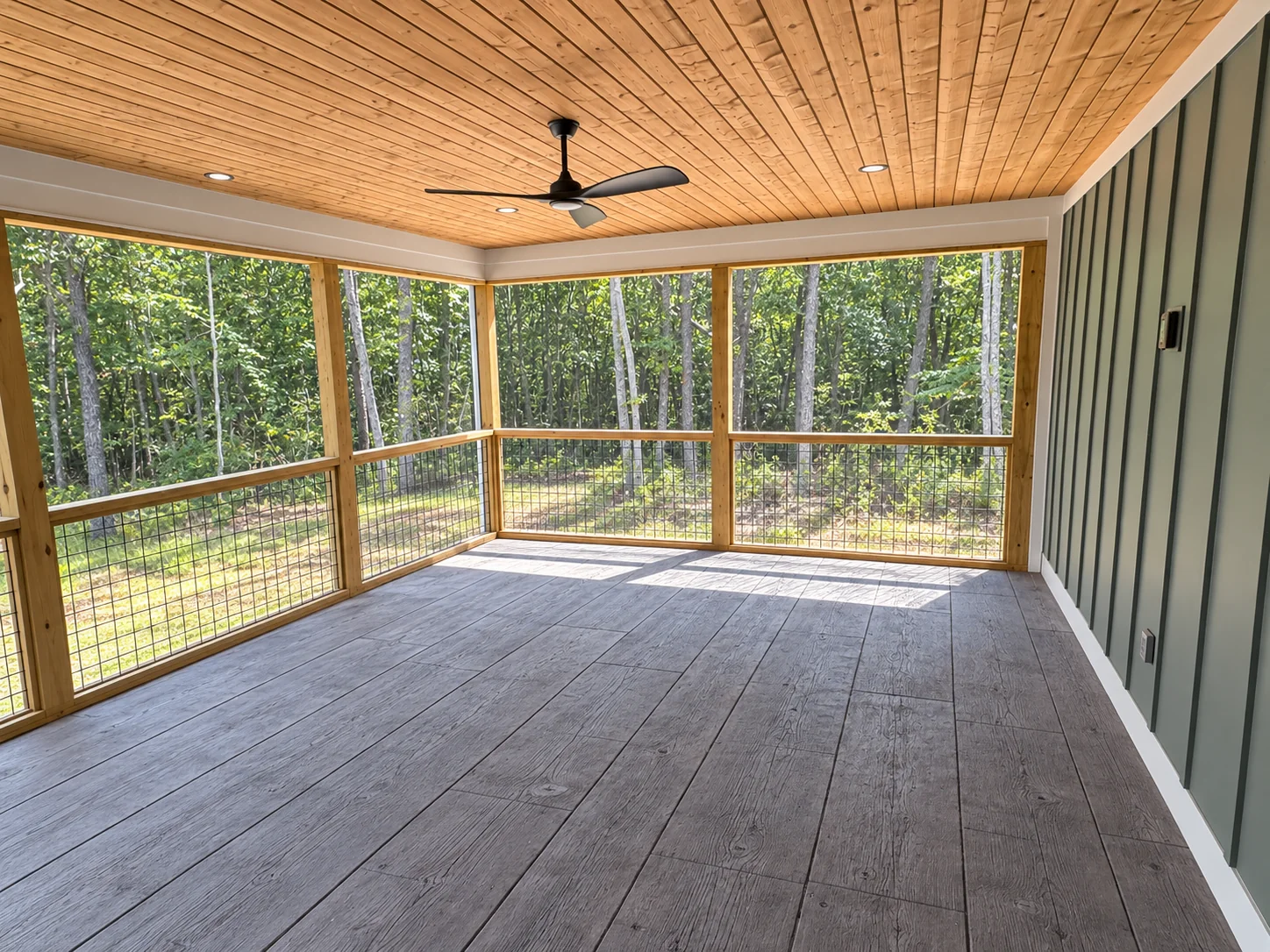 Fox Hill screened porch with a wood plank ceiling and ceiling fan looking into the trees