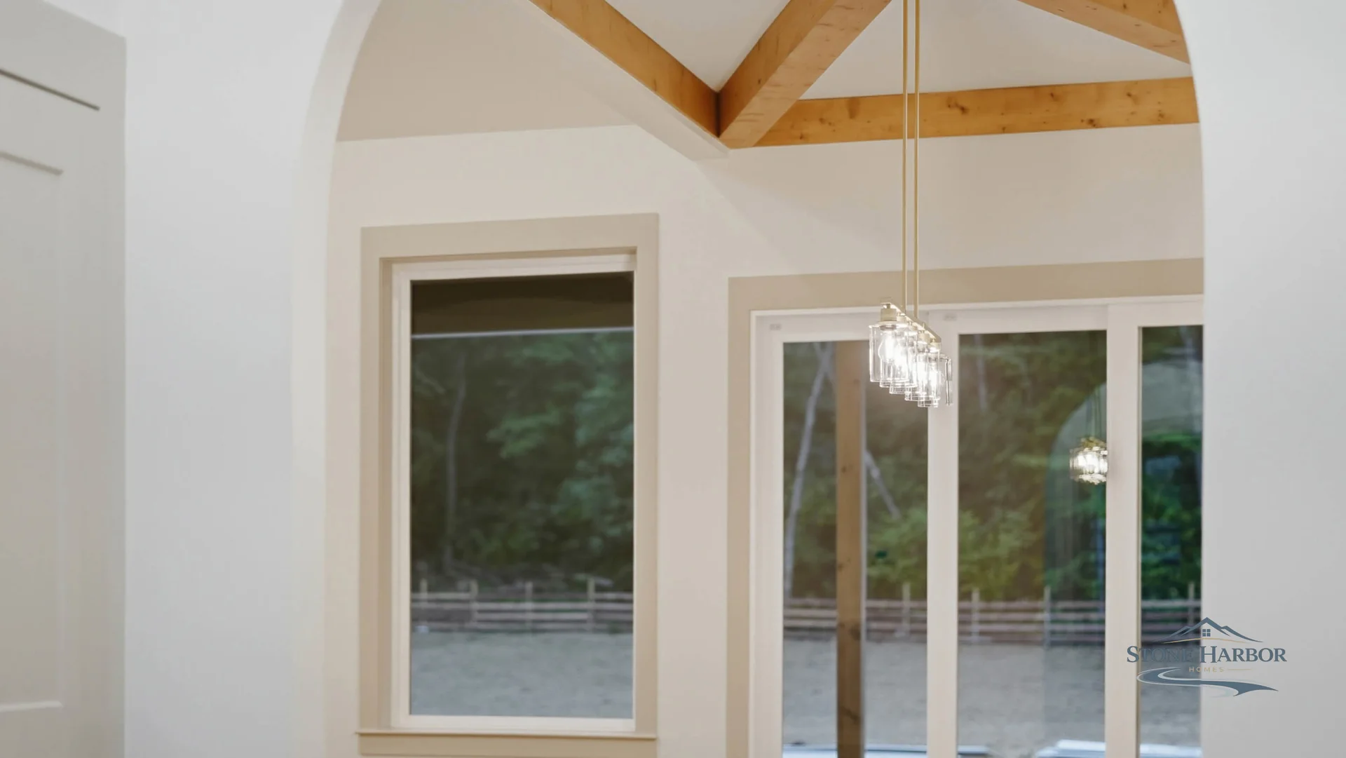 Green Pond dining area with vaulted, beamed ceiling and back doors