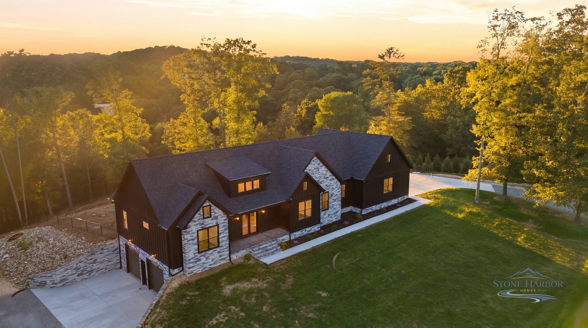 Aerial view of Hixson 2 on its wooded lot at golden hour