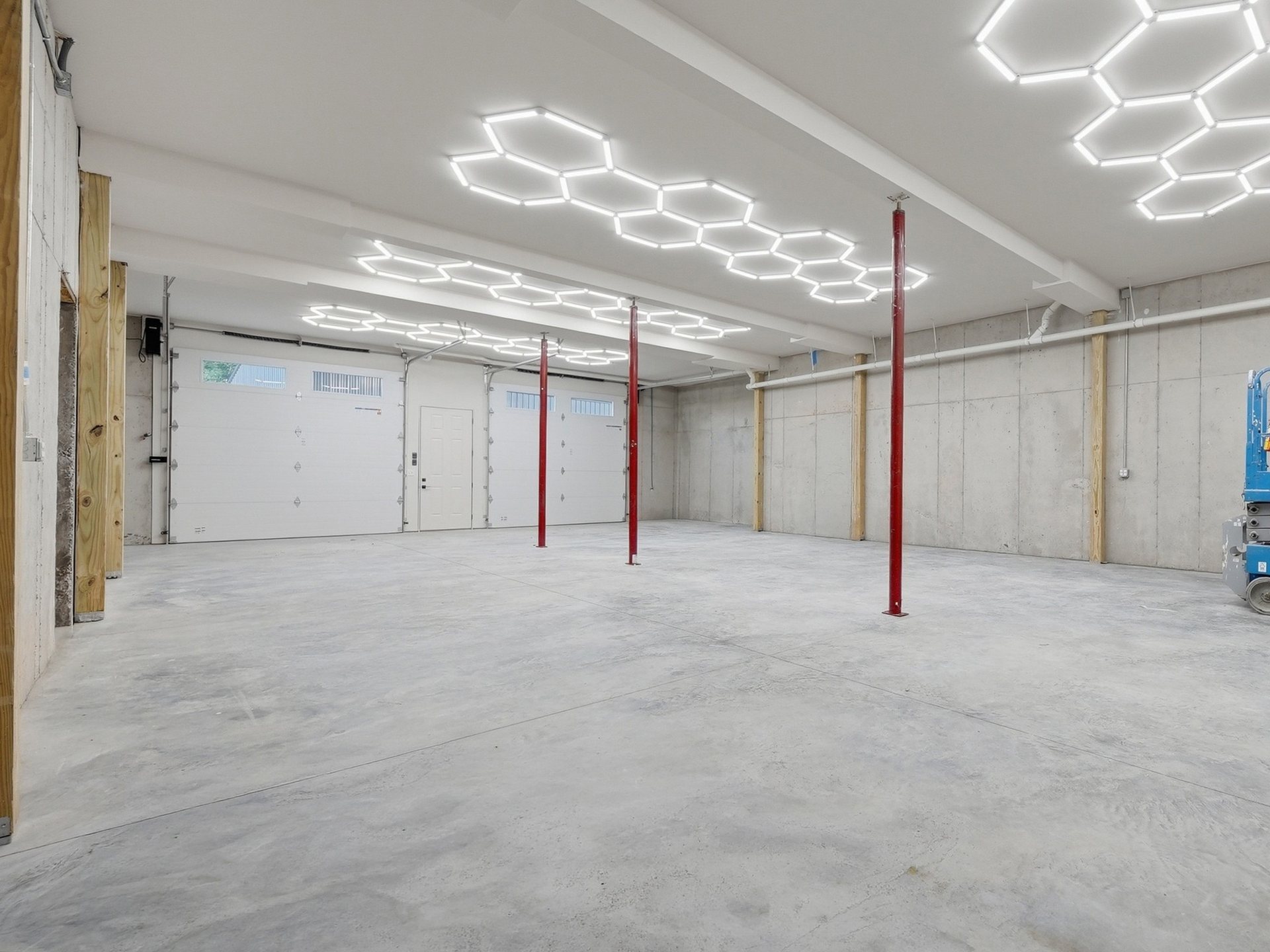 Poured-concrete lower level with twelve-foot ceilings, shown before finish-out