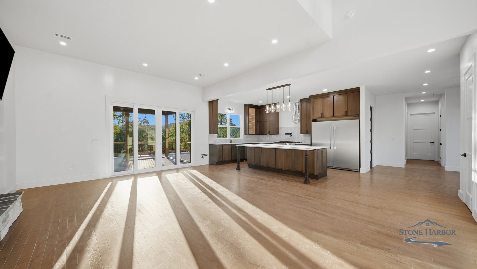 Vaulted open-plan kitchen with a large island and stained-wood cabinetry