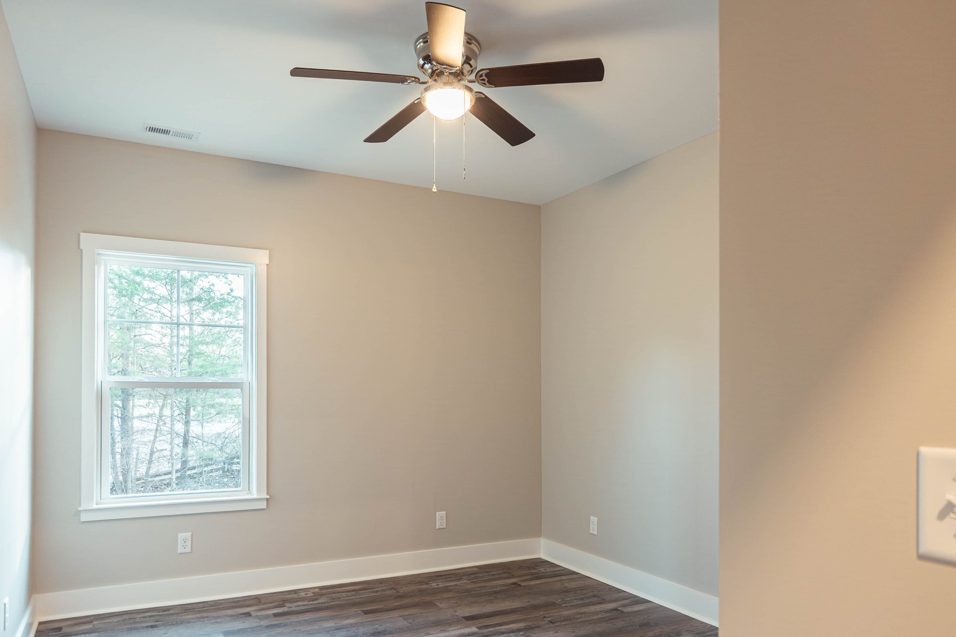 Lightning Drive secondary bedroom with a ceiling fan and window