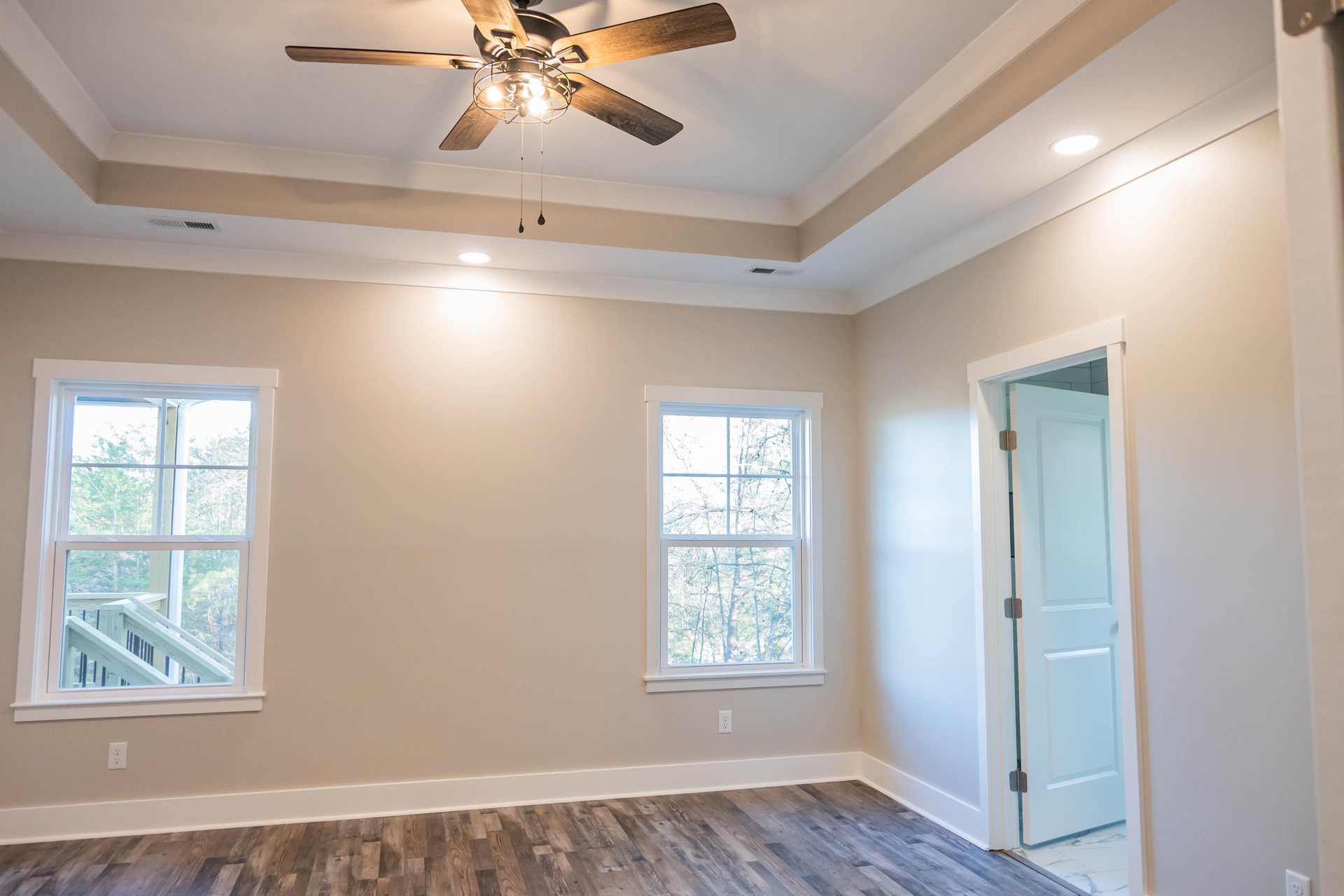 Lightning Drive primary bedroom with a tray ceiling