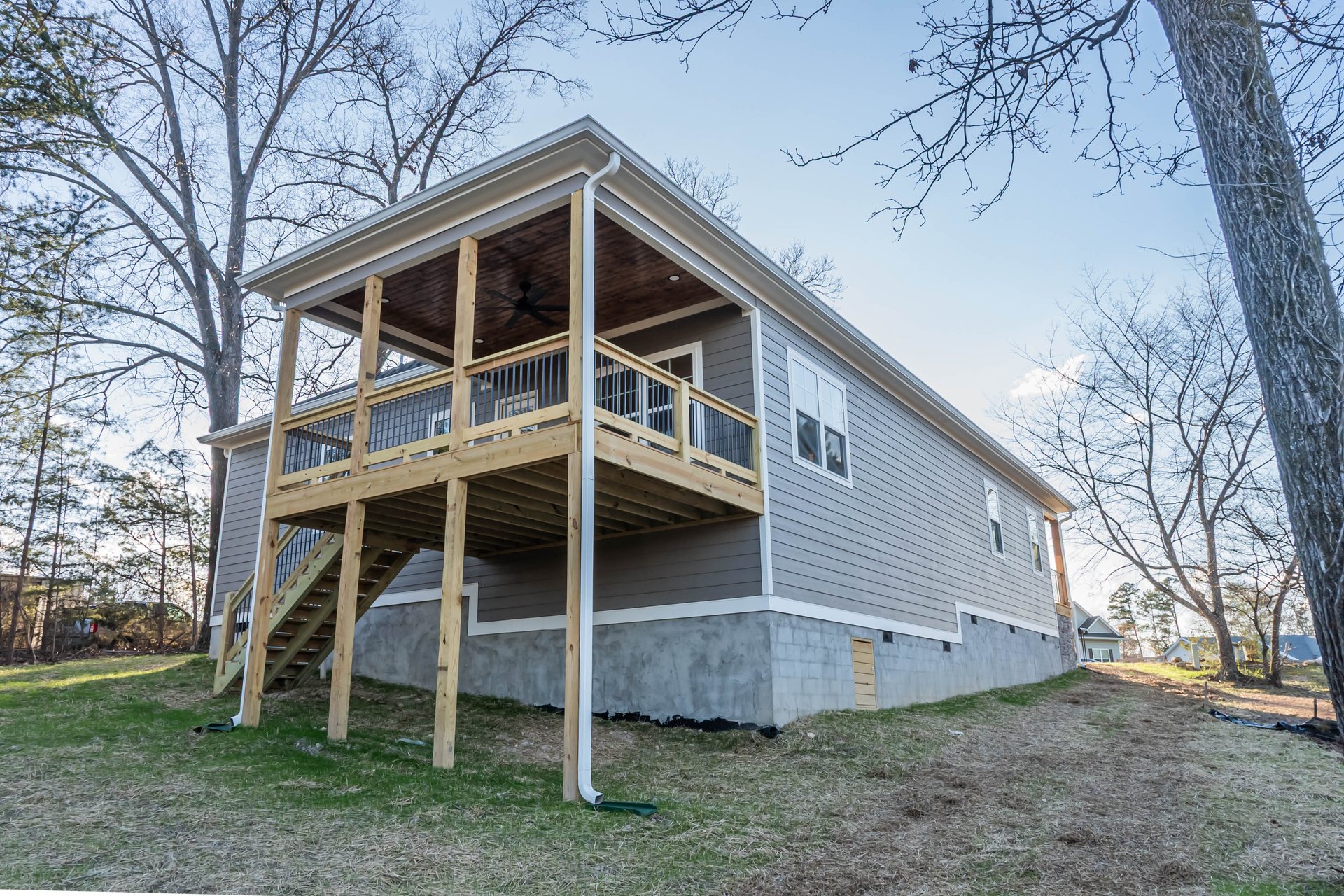 Lightning Drive rear exterior with an elevated deck on the sloped lot