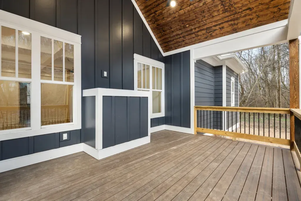 Pickett Gulf covered back porch with wood plank ceiling and dark blue siding
