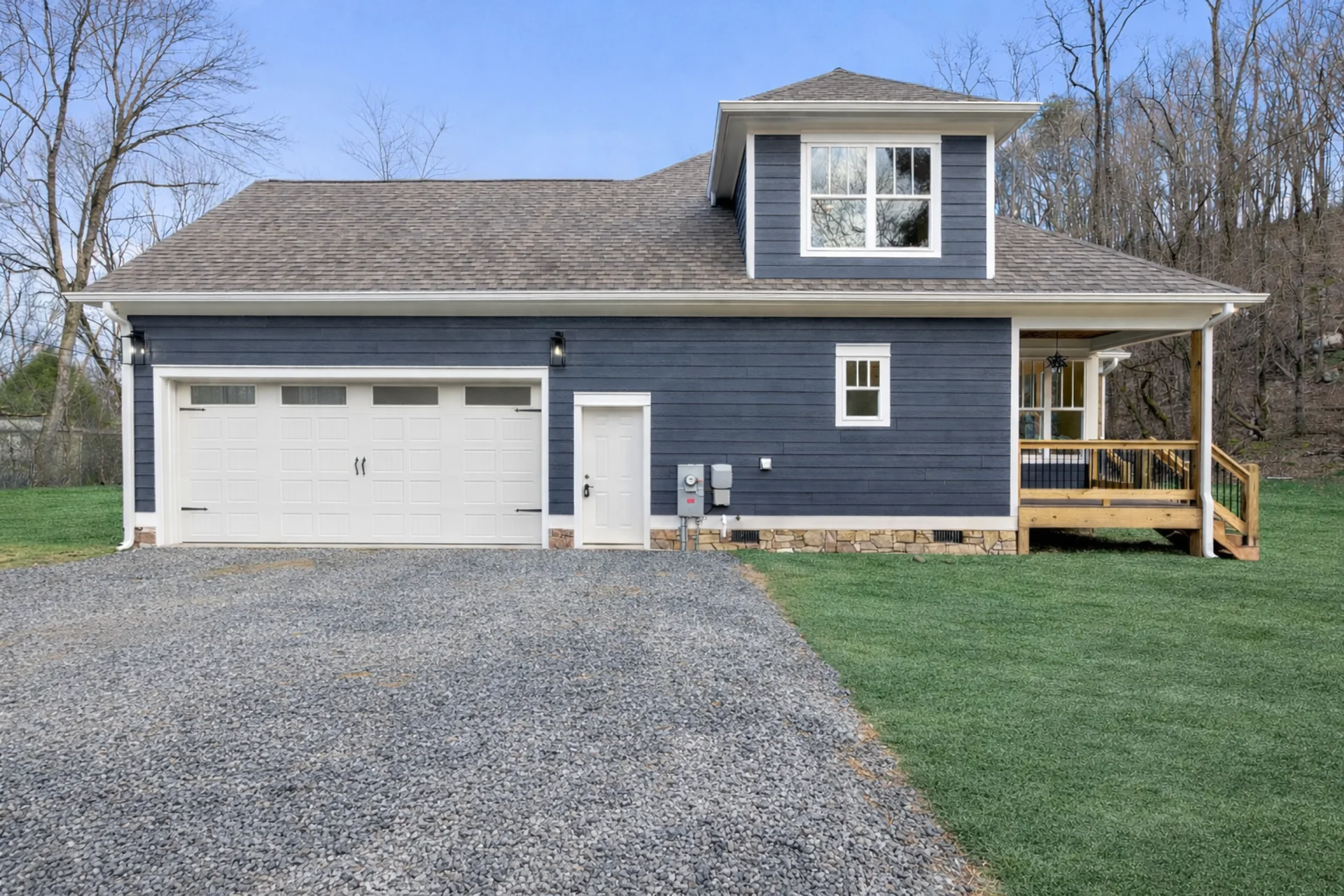 Pickett Gulf side exterior showing the attached garage and rear deck