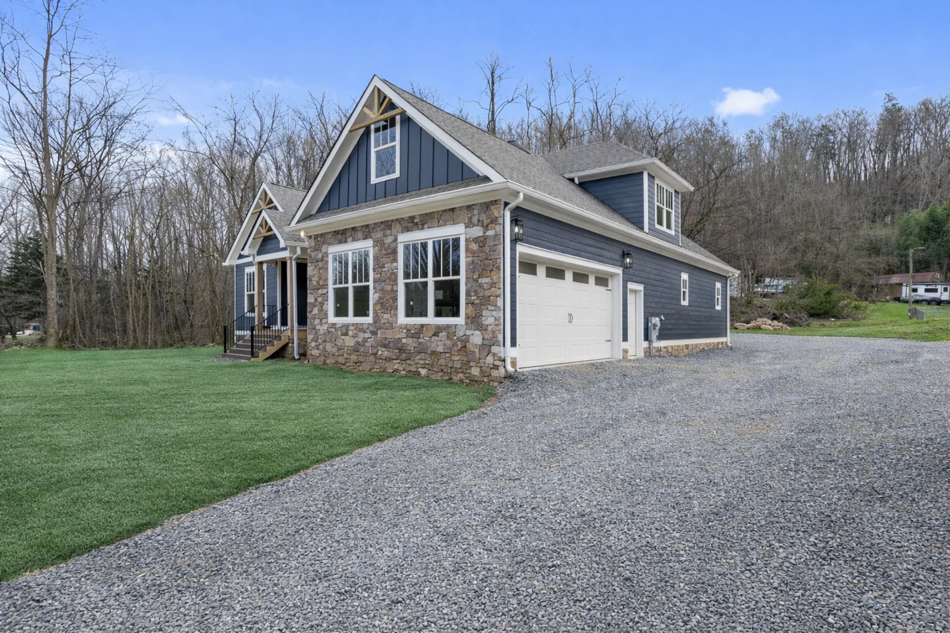 Pickett Gulf three-quarter exterior view showing the stone front, board-and-batten siding, and gravel drive