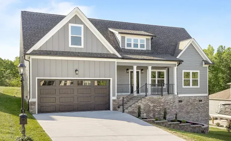 A Stone Harbor custom home with mixed gabled siding, board-and-batten accents, and a covered front porch